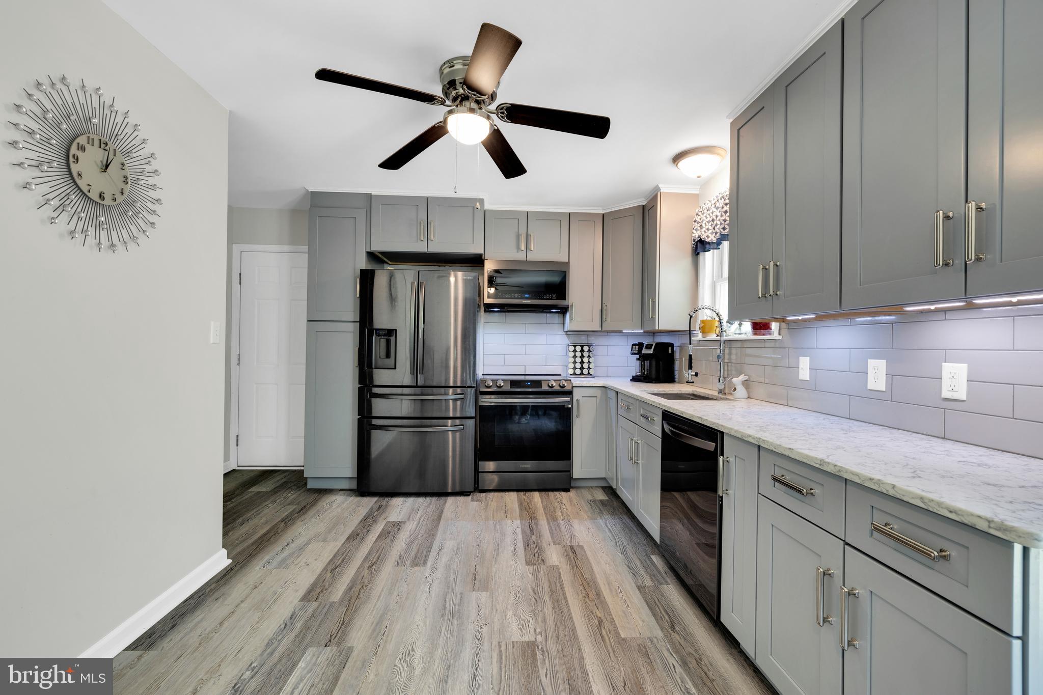 97 Bertolet Mill Road Oley, PA 19547 - Photo 11 of 35 a kitchen with stainless steel appliances granite countertop a stove a refrigerator and a sink