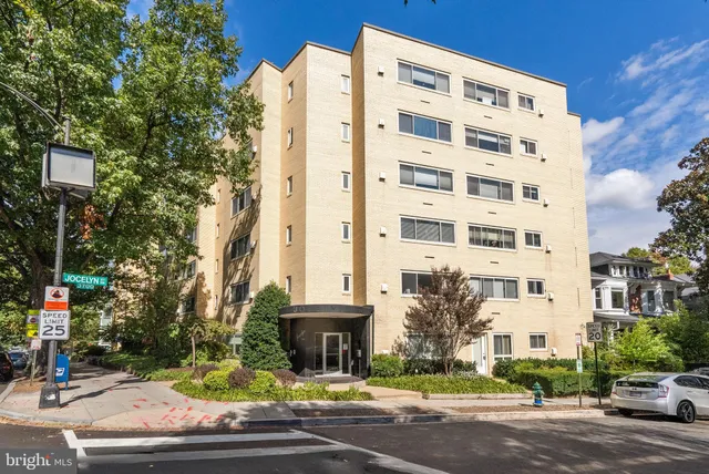 a view of a tall building next to a road