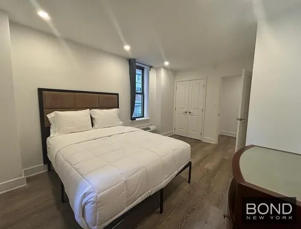 a bedroom with a bed and a potted plant