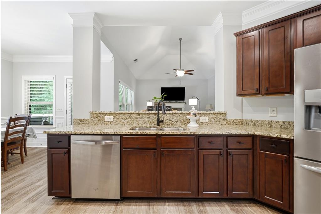 302 Spence Circle Ball Ground, GA 30107 - Photo 15 of 55 a kitchen with granite countertop a sink cabinets and wooden floor