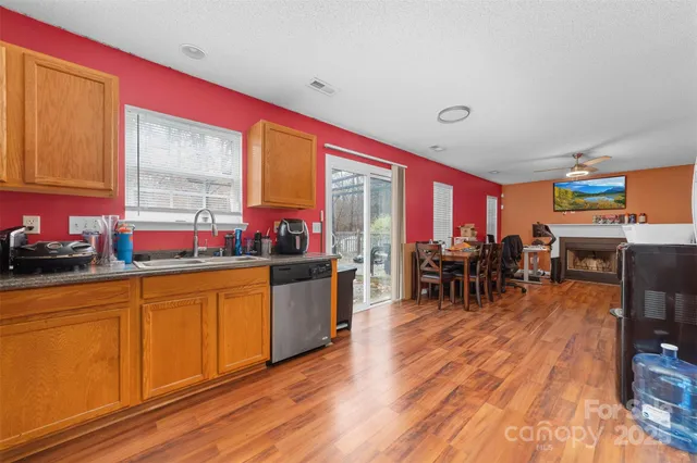 a very nice looking kitchen with a large window a dining table and chairs