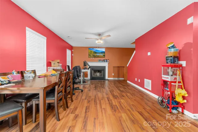a very nice looking room with wooden floor and furniture