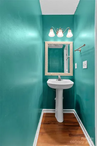 a bathroom with a sink toilet and a mirror