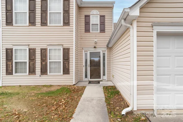 a view of a brick house with many windows