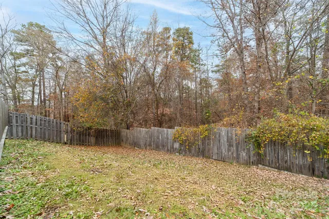 a backyard of a house with a large tree