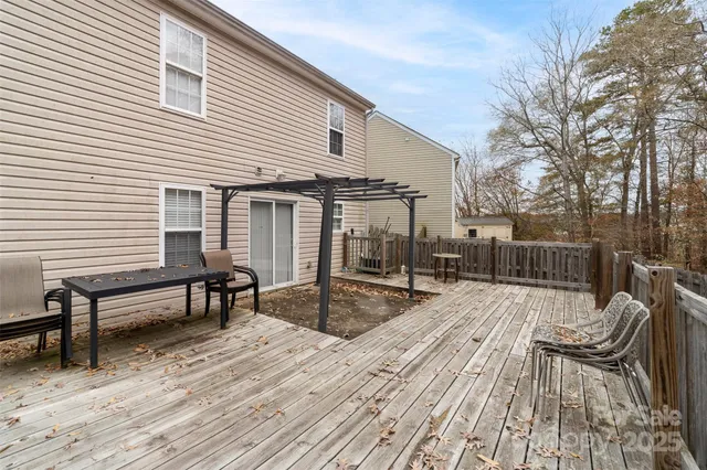 a view of a roof deck with table and chairs and wooden floor