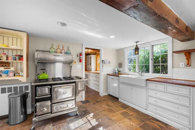 a kitchen with stainless steel appliances kitchen island granite countertop a stove a sink and a refrigerator