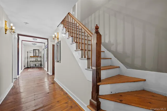 a view of entryway and hall with wooden floor