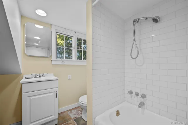 a bathroom with a sink toilet vanity and shower