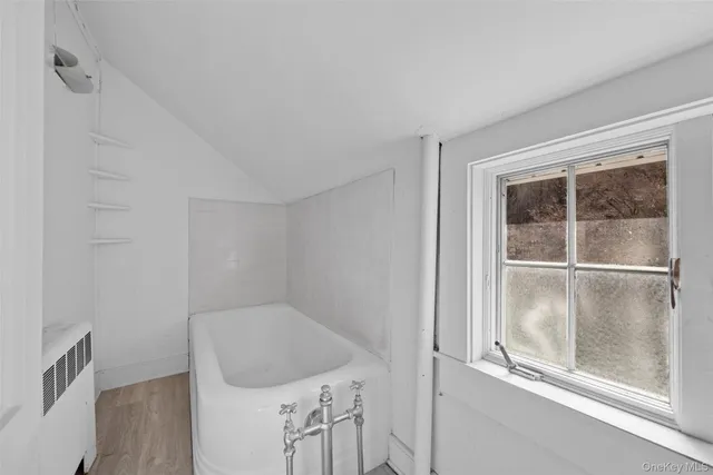 a bathroom with a bathtub and window