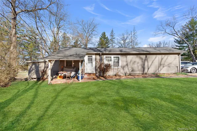 a view of a house with backyard sitting area and garden