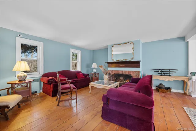 a living room with furniture fireplace and window