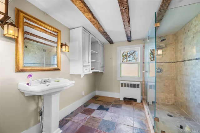 a bathroom with a sink a mirror and a shower