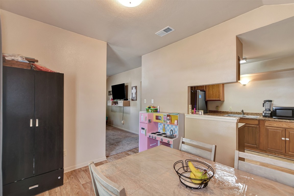 1920 6th Street Hempstead, TX 77445 - Photo 11 of 29 a kitchen with stainless steel appliances granite countertop a sink a stove a refrigerator cabinets and living room view