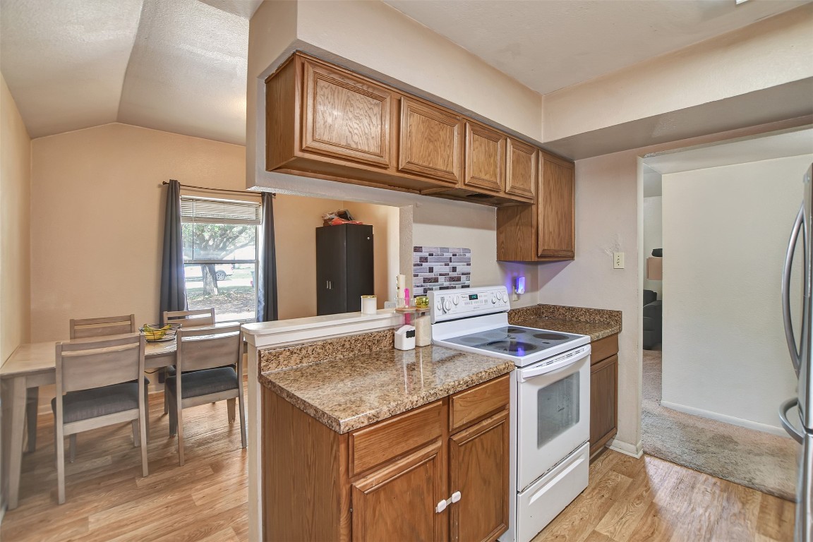 1920 6th Street Hempstead, TX 77445 - Photo 12 of 29 a kitchen with stainless steel appliances granite countertop a stove and a refrigerator