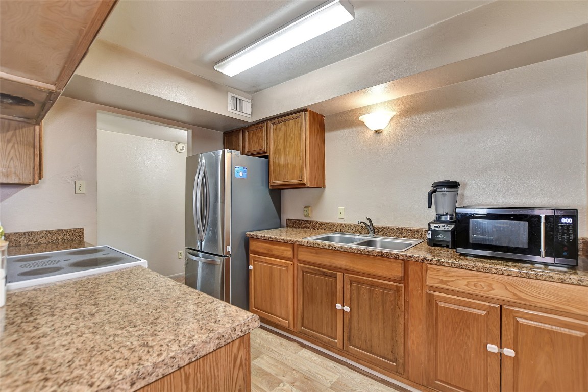 1920 6th Street Hempstead, TX 77445 - Photo 15 of 29 a kitchen with stainless steel appliances granite countertop a sink stove and refrigerator