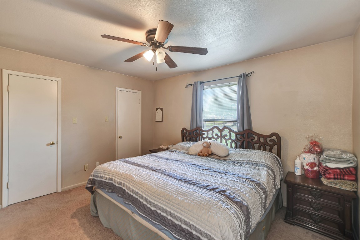 1920 6th Street Hempstead, TX 77445 - Photo 17 of 29 a bedroom with a bed and a chandelier