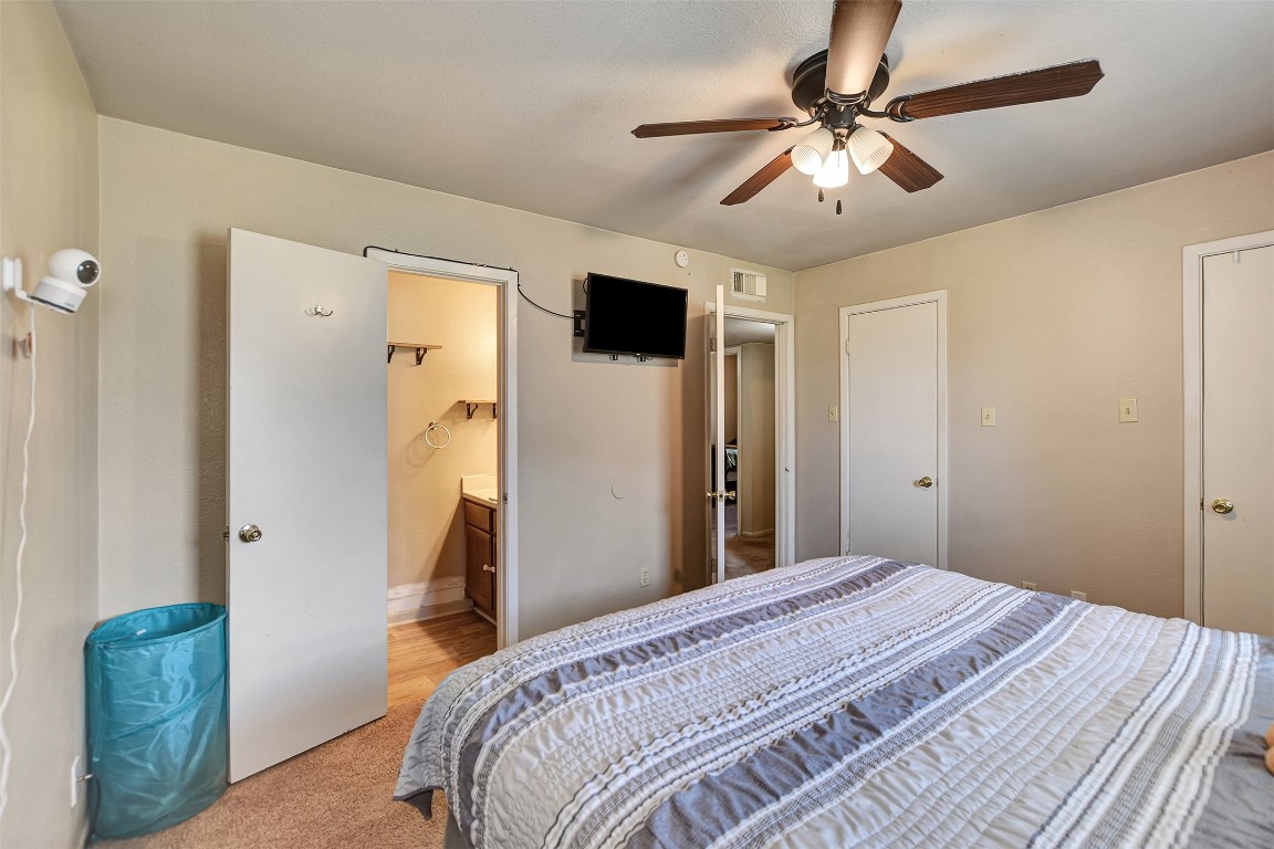 1920 6th Street Hempstead, TX 77445 - Photo 18 of 29 a bedroom with a bed and a chandelier