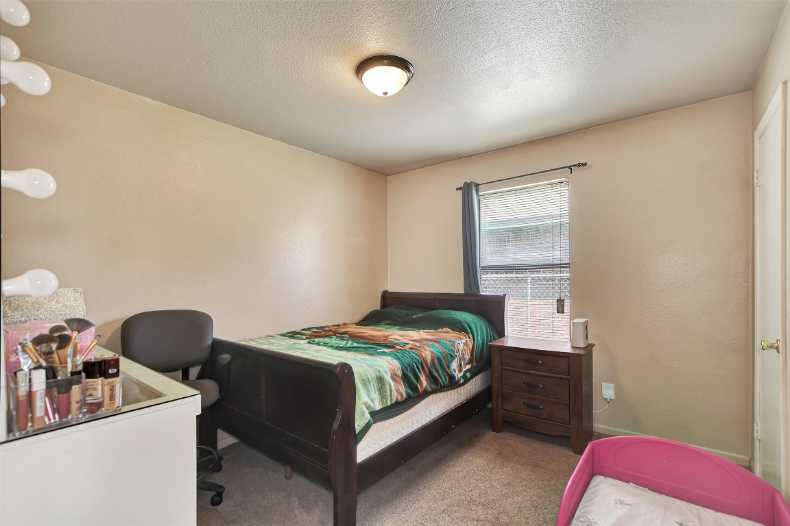 1920 6th Street Hempstead, TX 77445 - Photo 19 of 29 a bedroom with a bed and a chair