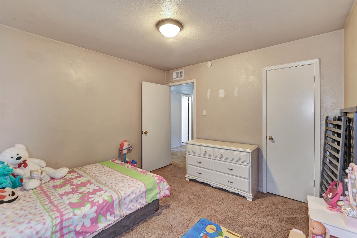 1920 6th Street Hempstead, TX 77445 - Photo 22 of 29 a bedroom with a bed and a dresser