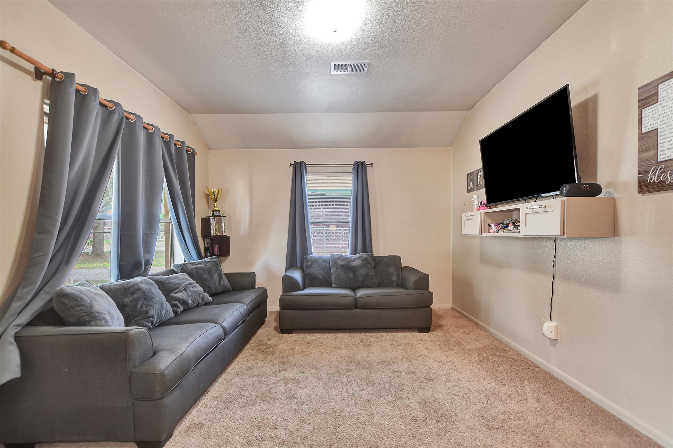 1920 6th Street Hempstead, TX 77445 - Photo 4 of 29 Step inside to an inviting, open living area filled with natural light from large windows, creating a bright and airy atmosphere.