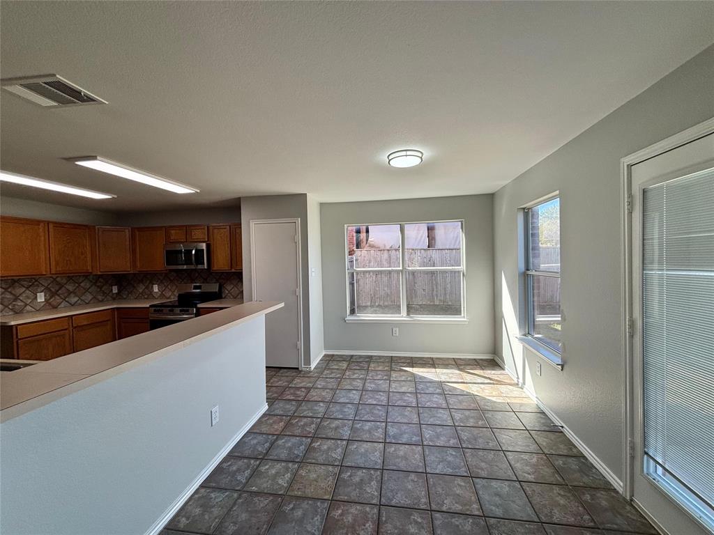 1003 Windsor Lane Forney, TX 75126 - Photo 12 of 20 a large white kitchen with a sink and a stove top oven