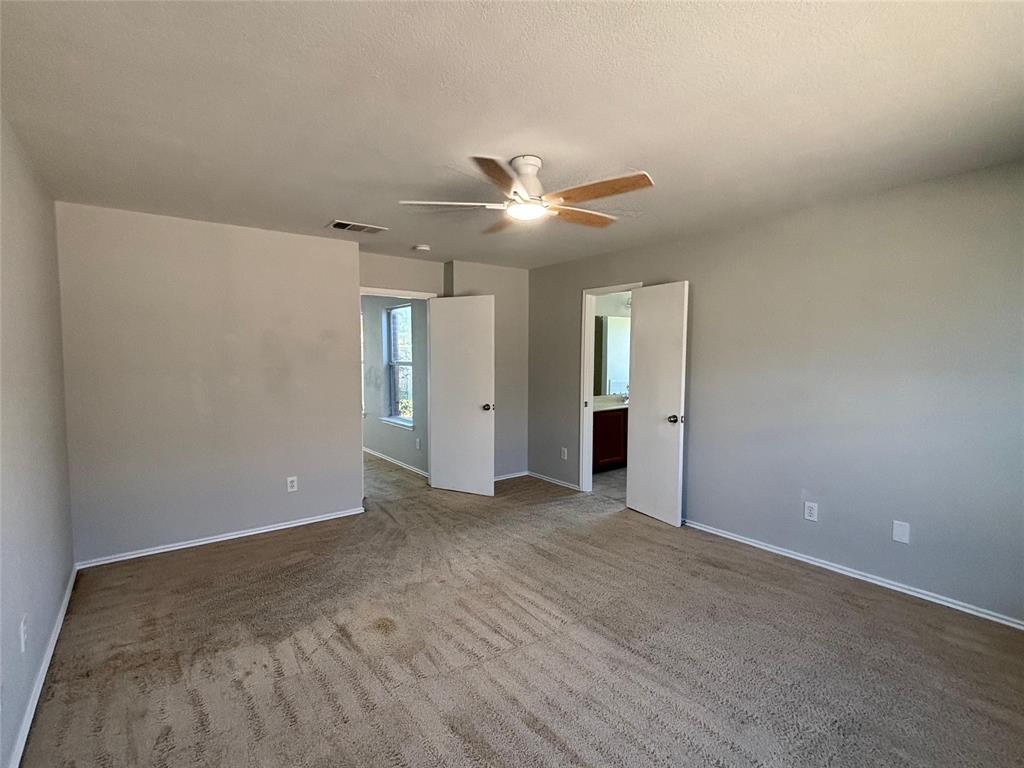 1003 Windsor Lane Forney, TX 75126 - Photo 13 of 20 a view of an empty room with a ceiling fan