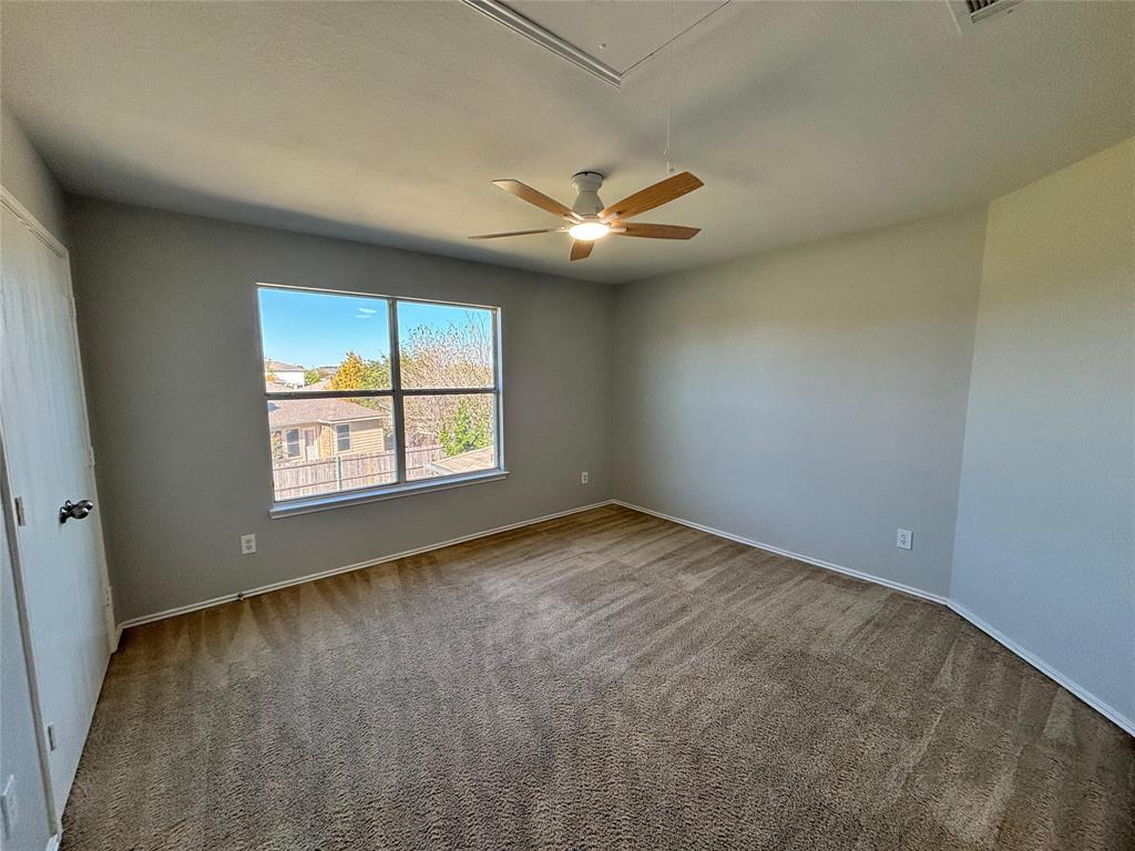 1003 Windsor Lane Forney, TX 75126 - Photo 17 of 20 an empty room with windows and ceiling fan
