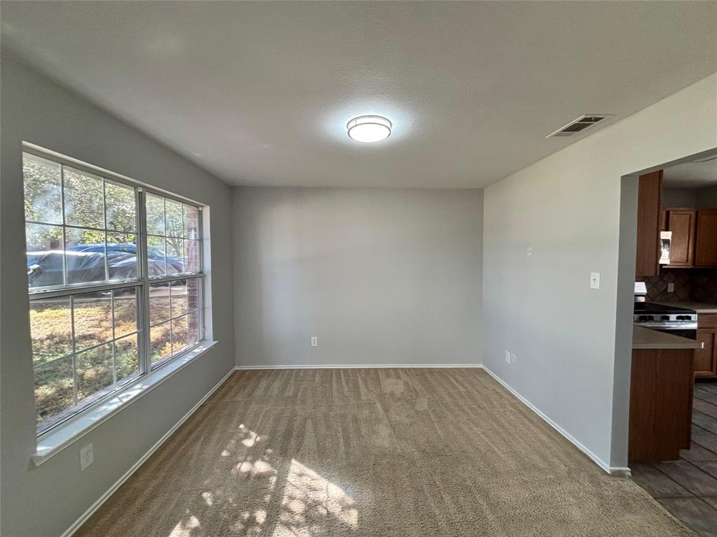 1003 Windsor Lane Forney, TX 75126 - Photo 5 of 20 an empty room with wooden floor and windows