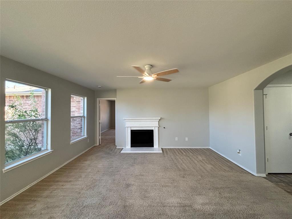 1003 Windsor Lane Forney, TX 75126 - Photo 8 of 20 an empty room with windows and fireplace