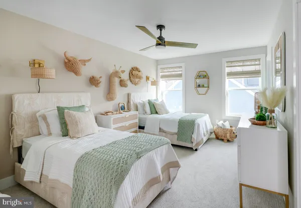 a bedroom with two beds and a window