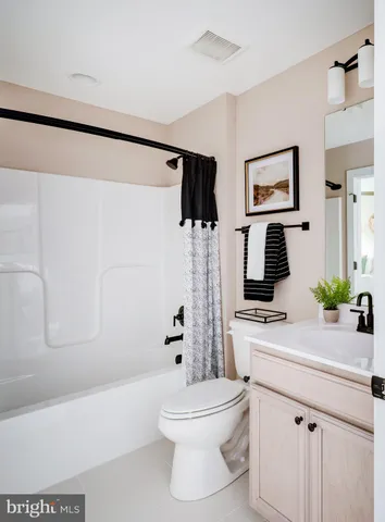 a bathroom with a sink a toilet a mirror and shower