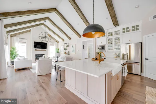 a hallway with white cabinets and wooden floor