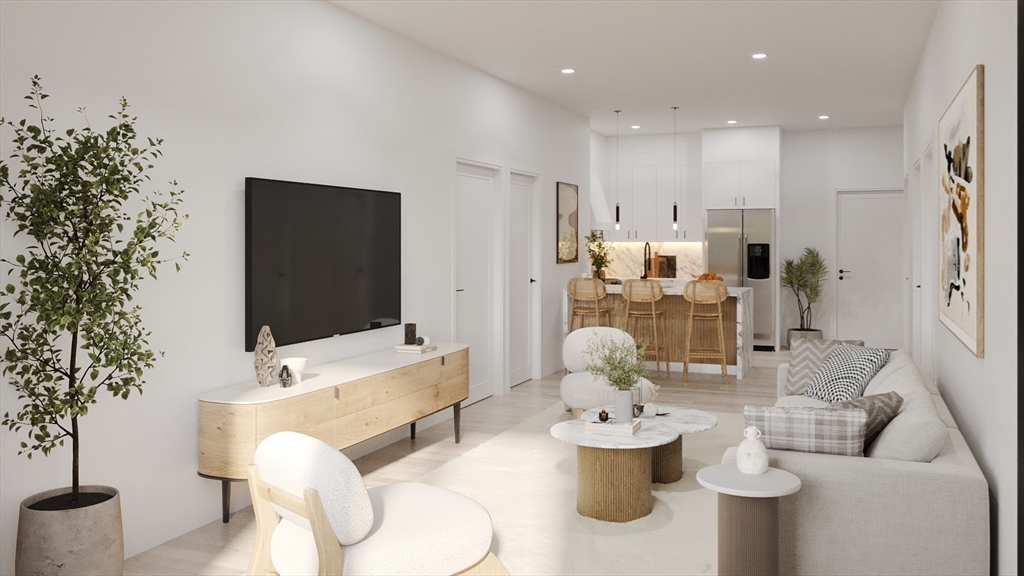 84 Prospect Street, Unit 101 Somerville, MA 02143 - Photo 3 of 6 a living room with furniture and a flat screen tv