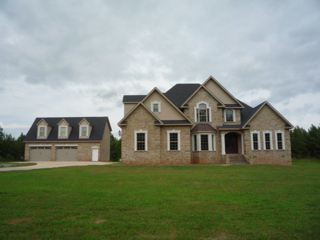 2045 Midway Road, Unit 2 Lizella, GA 31052 - Photo 1 of 1 a front view of a house with a garden