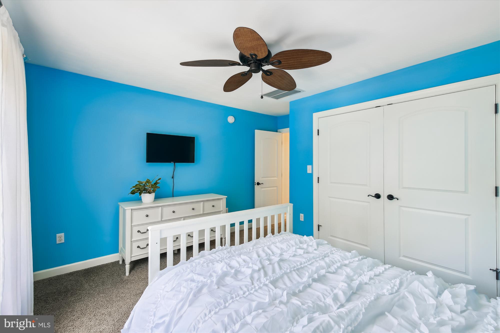 9044 Davis Road Pittsville, MD 21850 - Photo 35 of 43 a bedroom with a bed a flat screen tv and a ceiling fan