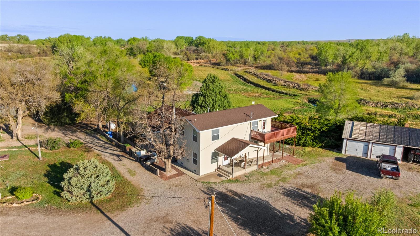 an aerial view of a house with a yard basket ball court and outdoor seating