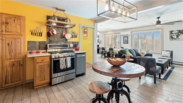 a kitchen with stainless steel appliances a stove a table and chairs