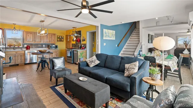 a living room with furniture and wooden floor