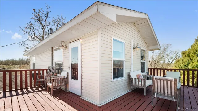 a view of a house with wooden deck