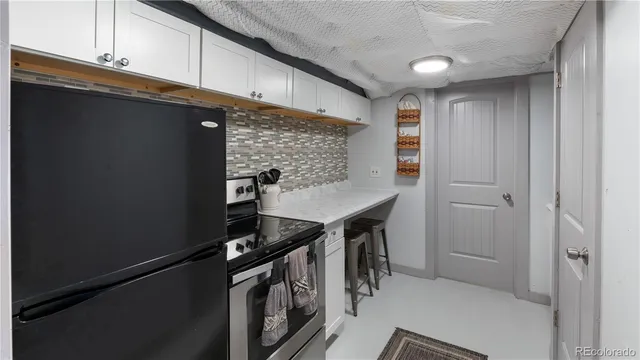 a kitchen with stainless steel appliances a refrigerator and cabinets