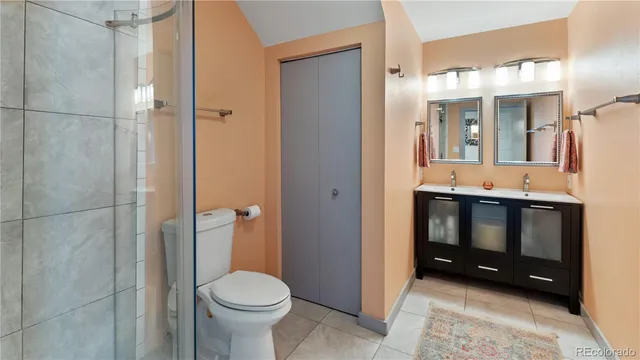 a bathroom with a toilet a sink and shower