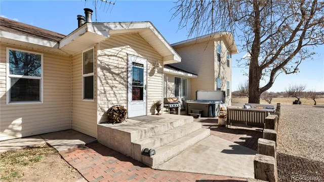 a building outdoor space with patio furniture and potted plants