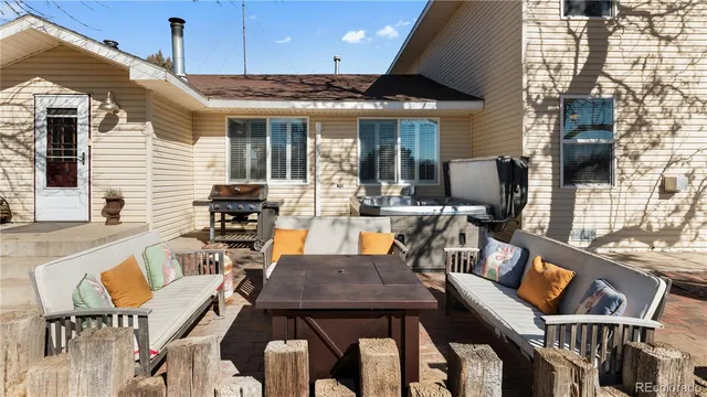 a view of a patio with table and chairs with wooden floor