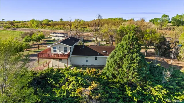 a aerial view of a house with a garden and lake view