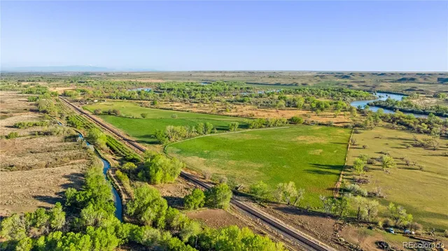 an aerial view of ocean with residential building in background