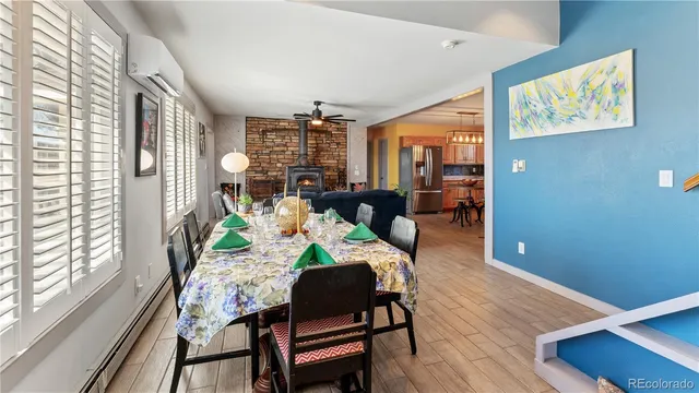 a view of a dining room with furniture a chandelier and wooden floor