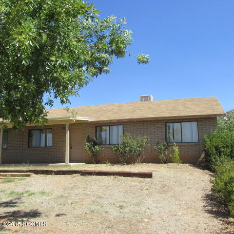 1331 Suave Court Rio Rico, AZ 85648 - Photo 1 of 8 a front view of a house with garden