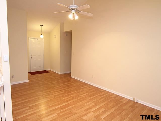 3605 Christine Court Raleigh, NC 27604 - Photo 3 of 12 a view of an empty room with wooden floor and a ceiling fan