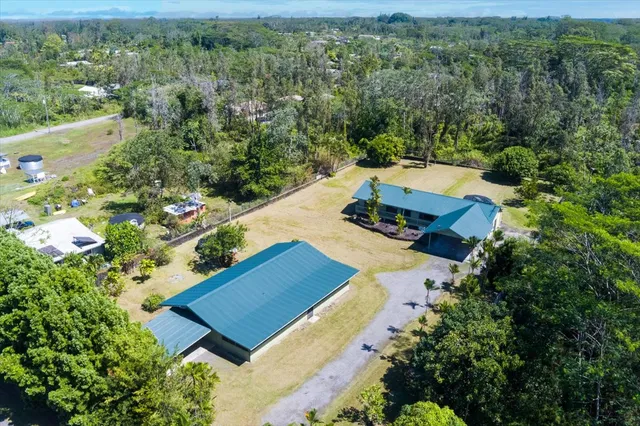 an aerial view of a house with a yard